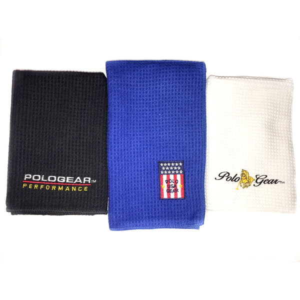Set of three hand towels. A black towel is on the left, embroidered with a PoloGear Performance logo, a blue towel is in the middle with a PoloGear USA logo, and a white hand towel is on the right, embroidered with the classic PoloGear logo.